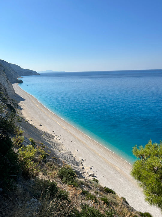 Breathtaking view of Egremni Beach in Lefkada, Greece, featuring pristine white sand, dramatic cliffs, and the vibrant turquoise waters of the Ionian Sea, a must-visit destination for nature lovers and beach enthusiasts.